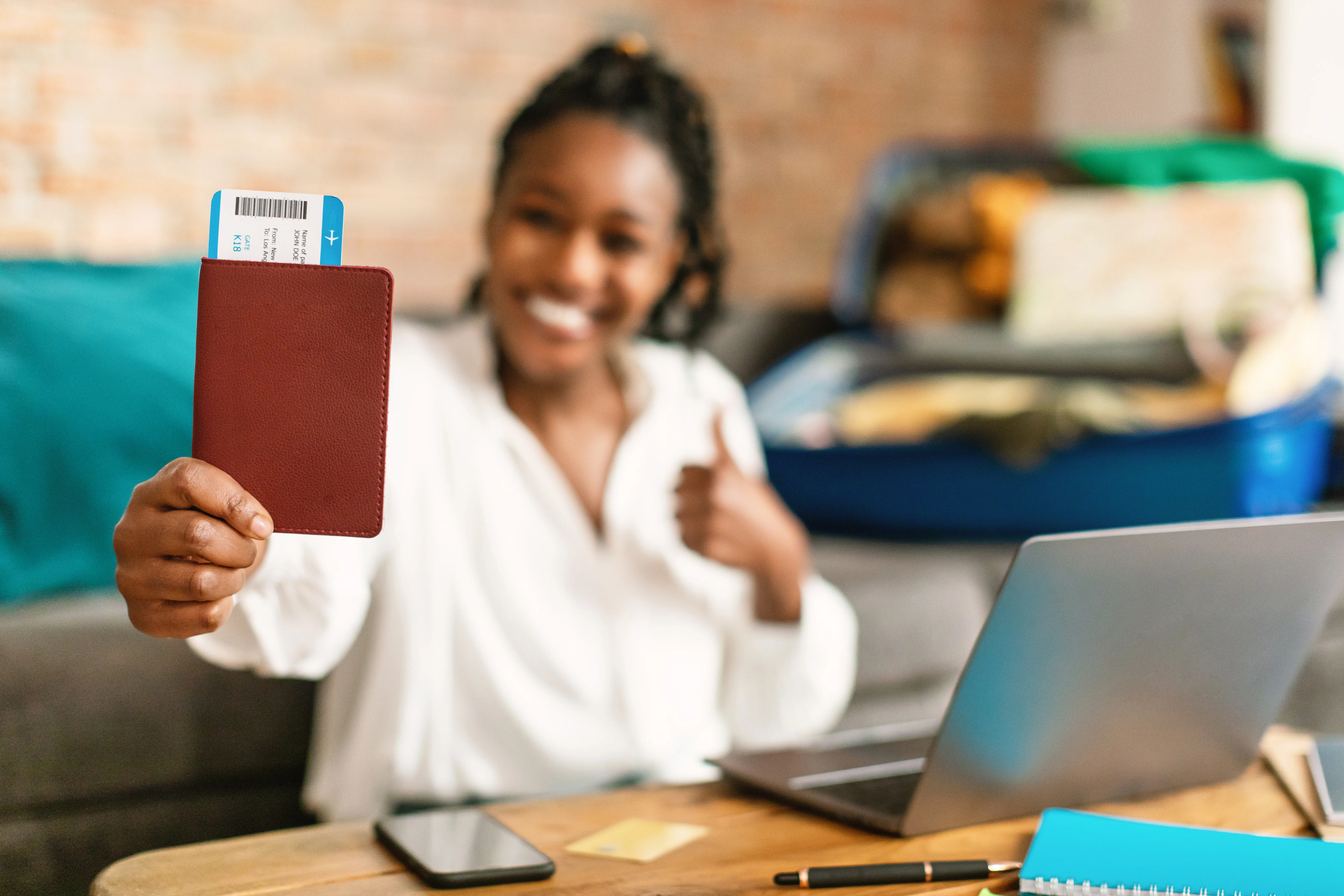 Happy woman holding a flight ticket